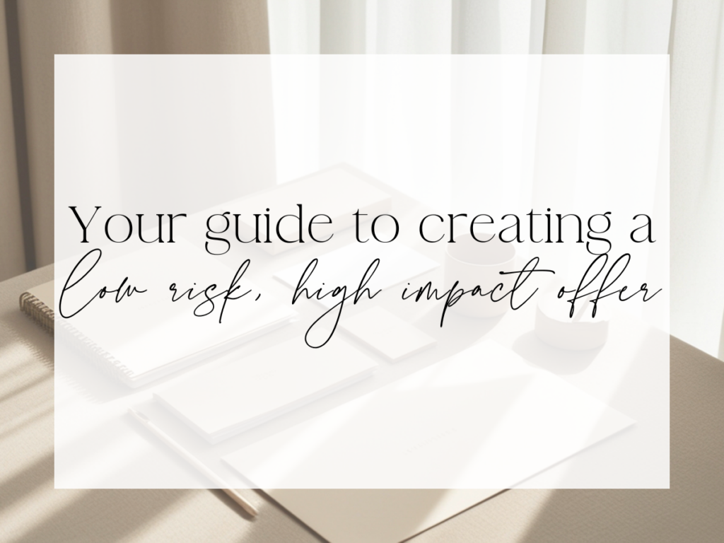 Soft, sunlit desk scene with notebooks, paper, and coffee mugs in neutral tones. Over a white overlay, the text reads: “Your guide to creating a low risk, high impact offer.”