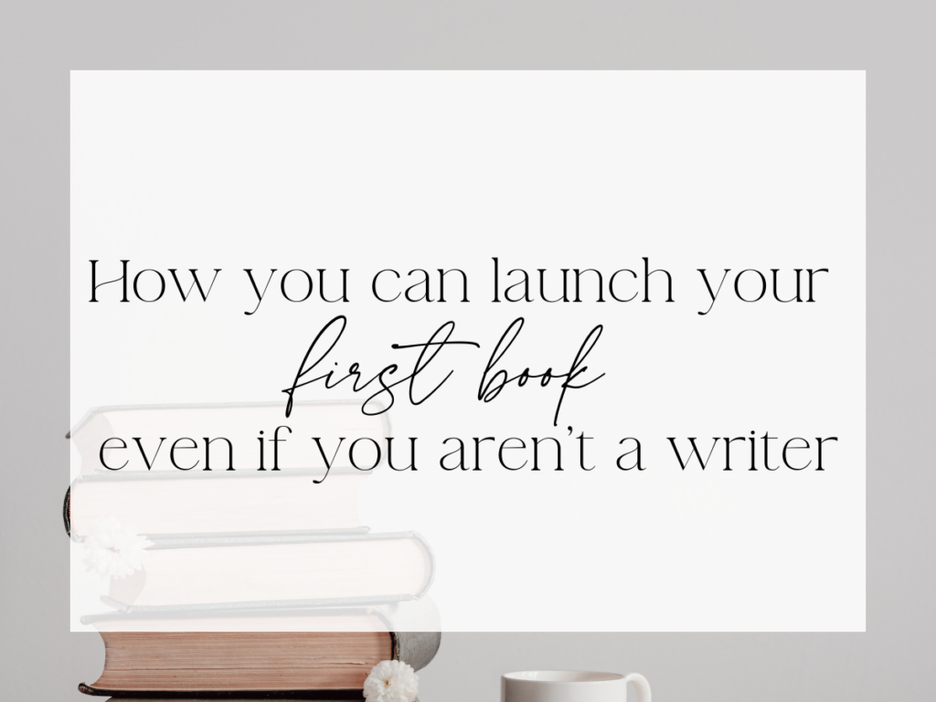 Minimal, neutral graphic with a soft gray background and a white overlay. A small stack of hardcover books appears in the lower left corner, with a mug partially visible near the bottom. Centered text in serif and script fonts reads: “How you can launch your first book, even if you aren’t a writer.”