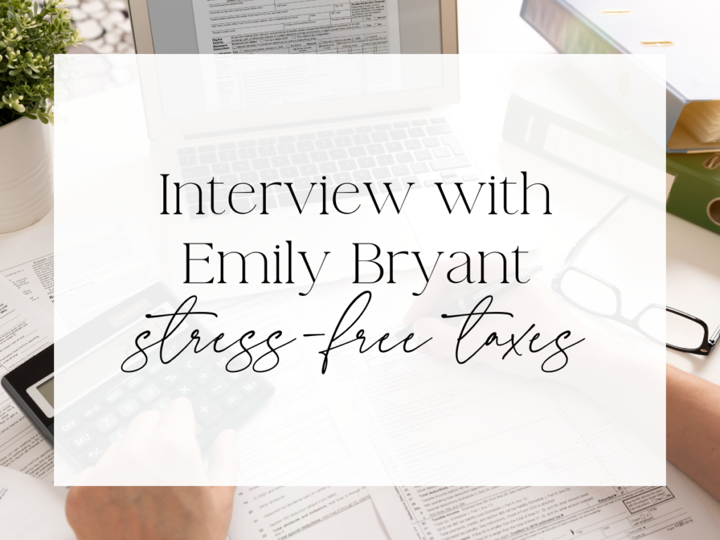 Overhead view of a desk with tax documents, a laptop, calculator, glasses, and binders. A soft white overlay displays serif and script text reading: “Interview with Emily Bryant: stress-free taxes.”