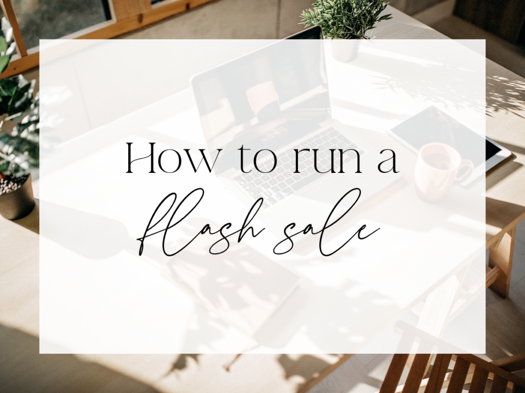 Sunlit workspace with a laptop, coffee mug, notebook, and potted plants on a wooden table. A soft white overlay displays elegant serif and script text reading: “How to run a flash sale.”